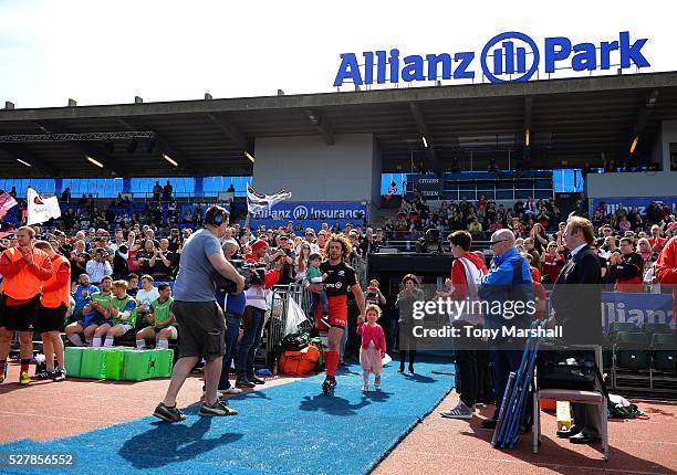 Jacques Burger of Saracens takes to the pitch with his children for his final match during the Aviva Premiership match between Saracens and Newcastle...