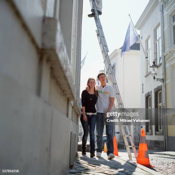 couple walking under ladder - luck stock pictures, royalty-free photos & images