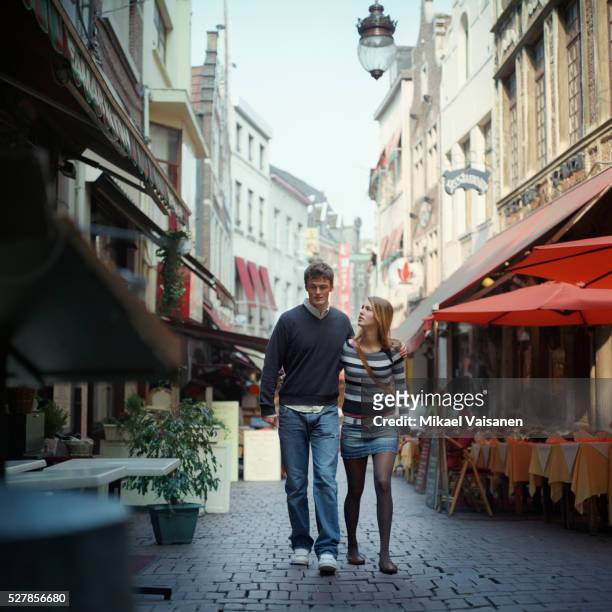 couple walking outdoors - brussels square stock pictures, royalty-free photos & images