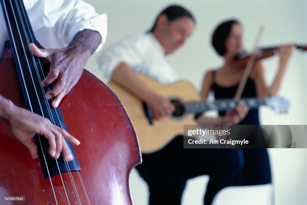 Musicians Playing Double Bass, Guitar, and Violin