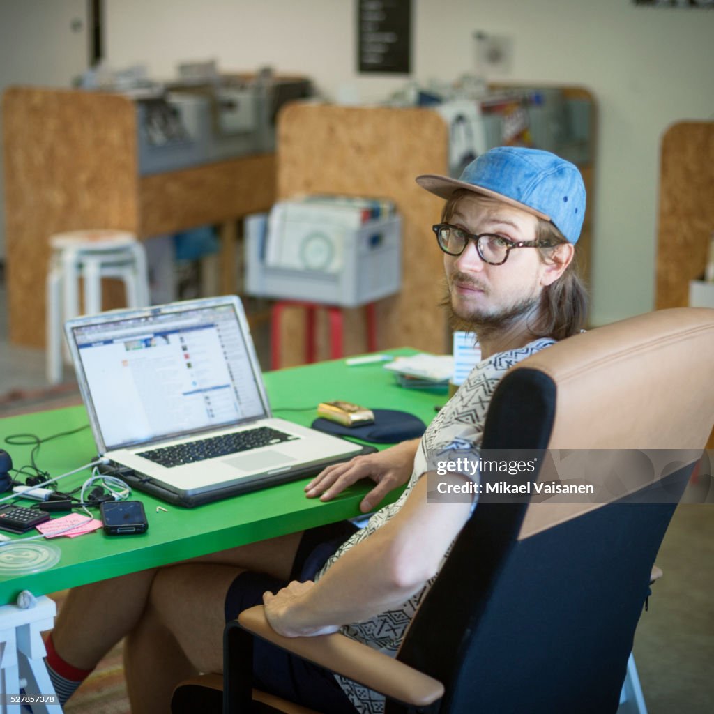 Record store owner sitting at office desk