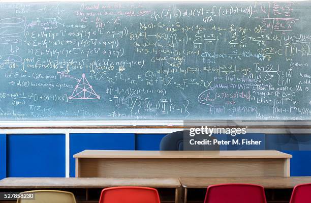 empty classroom with equations on blackboard - physics equation stock pictures, royalty-free photos & images