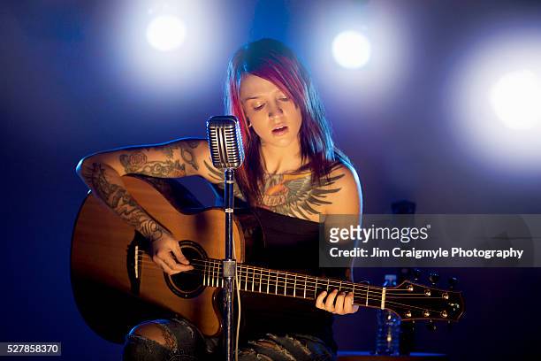 musician performing on stage - acoustic guitar stock pictures, royalty-free photos & images