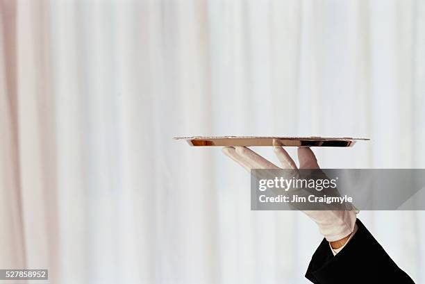 gloved hand of maitre d' holding tray - serving tray stock pictures, royalty-free photos & images