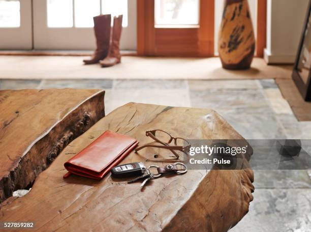 house interior with alarm device, glasses and wallet on table. - car keys table stock-fotos und bilder