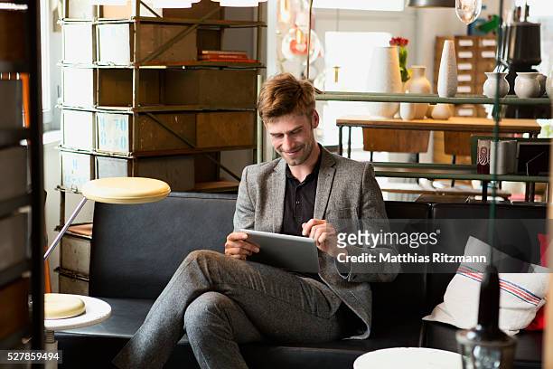 male interior designer using tablet pc in his studio - man in antique shop stock pictures, royalty-free photos & images