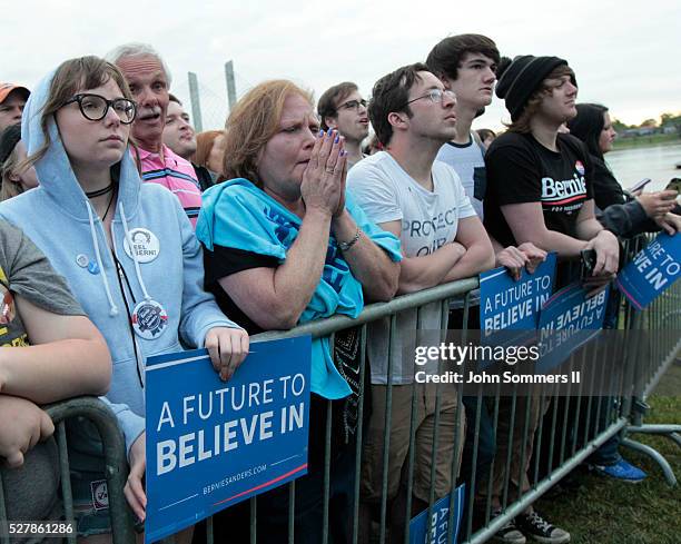 Campaign supporters show their support for Democratic presidential candidate Bernie Sanders as he speaks to them during a campaign rally at the Big...