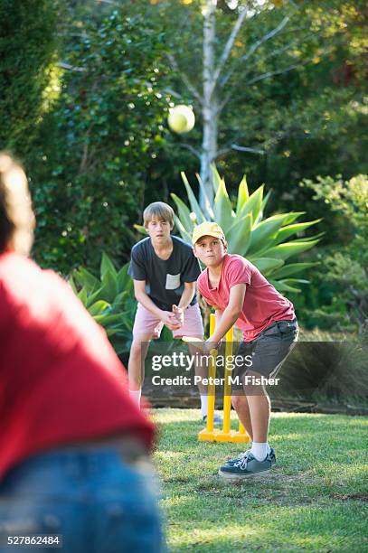 boys playing cricket in backyard - backyard cricket stock pictures, royalty-free photos & images