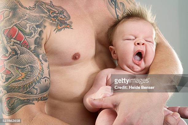 man carrying baby - white dragon tattoo stock pictures, royalty-free photos & images