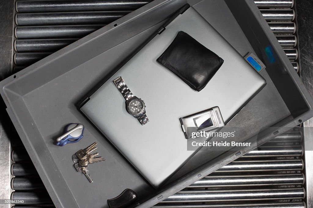 Personal Items in a Tub at a Security Screening Station