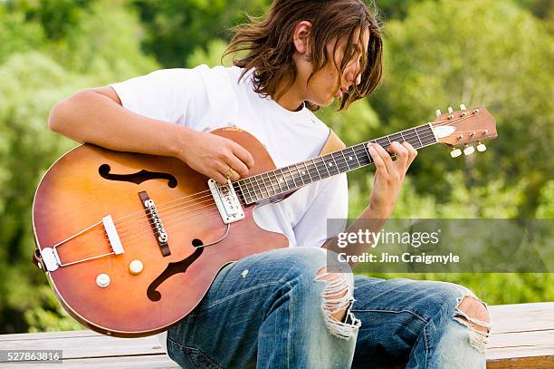 teenage boy playing guitar - jim craigmyle guitar stock pictures, royalty-free photos & images