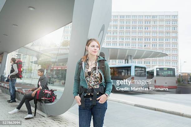 woman waiting at bus stop - bus station stock pictures, royalty-free photos & images