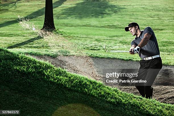 young man playing golf - golfschwung stock-fotos und bilder