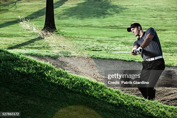 young man playing golf - swing de golf fotografías e imágenes de stock
