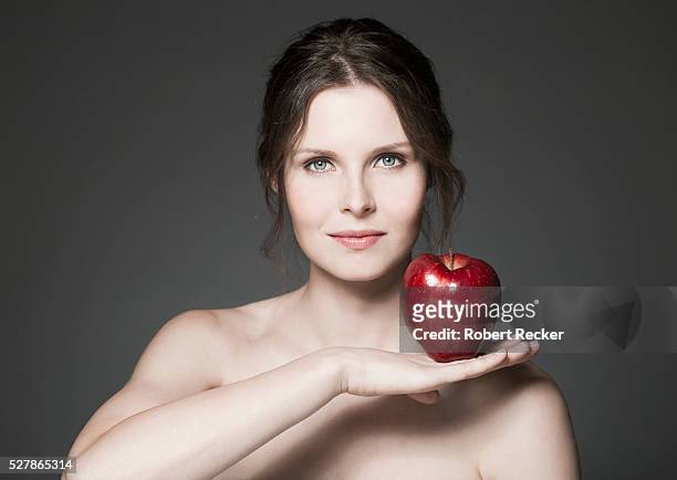 handsome woman with a red apple - young women no clothes stock pictures, royalty-free photos & images