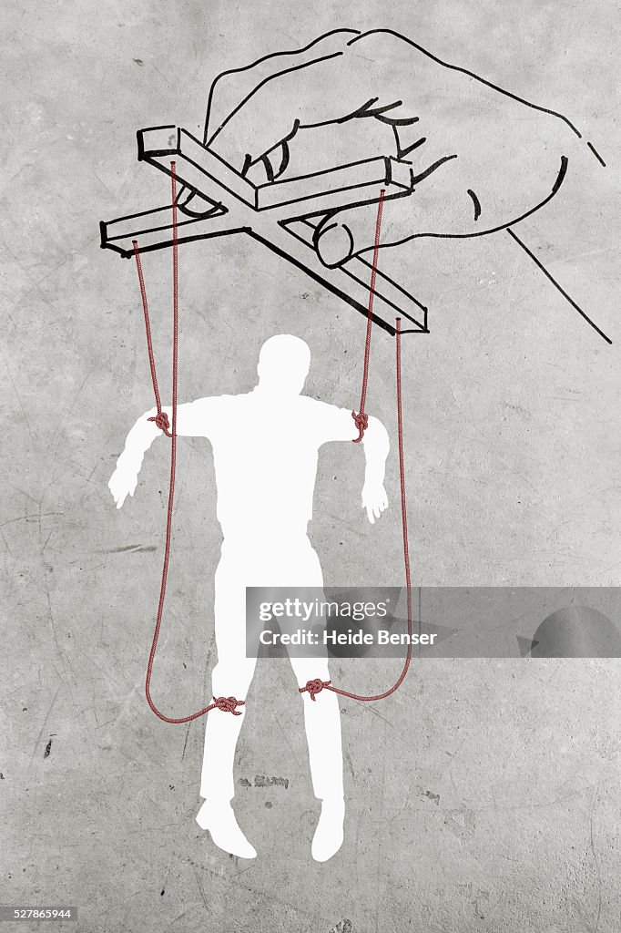 Silhouette of man dangling on threads