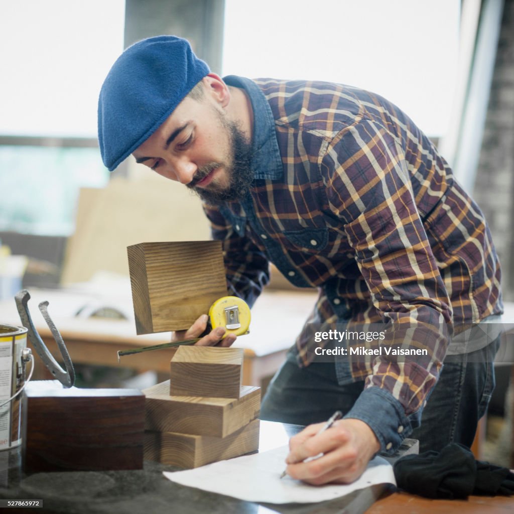 Young bearded carpenter at work