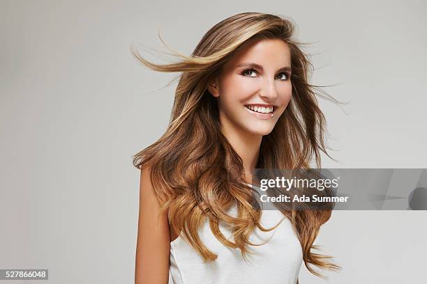 profile of woman with windblown wavy hair - hair extension stock pictures, royalty-free photos & images