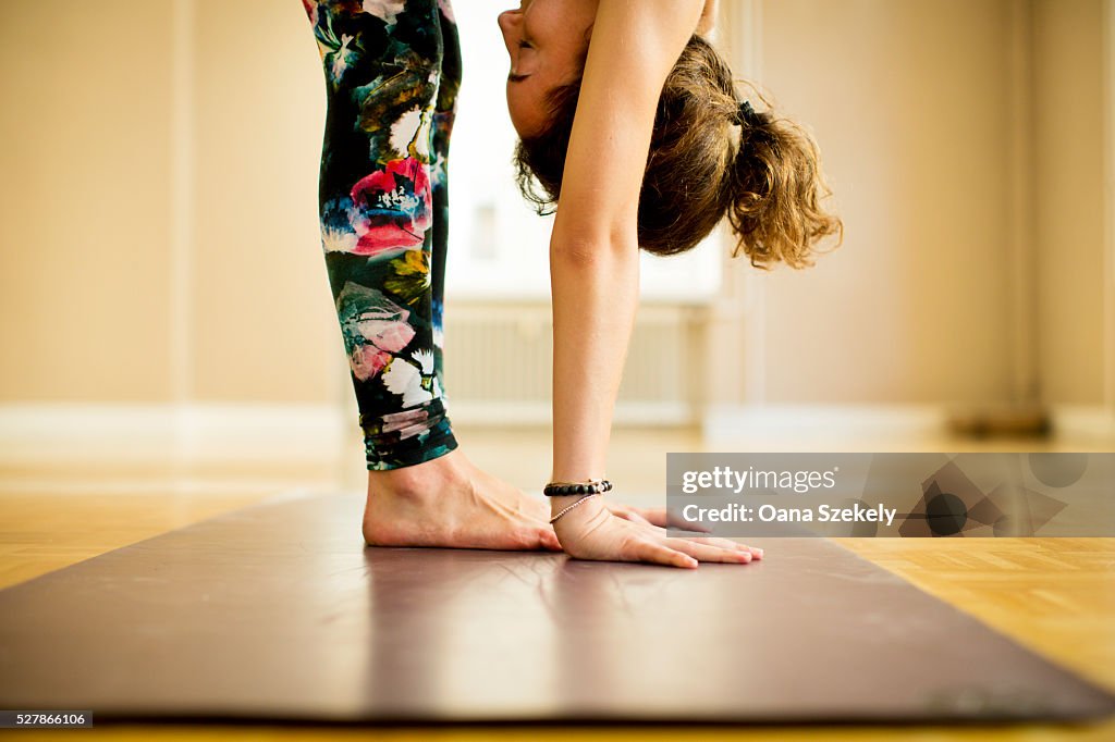 Young woman practicing Vinyasa yoga