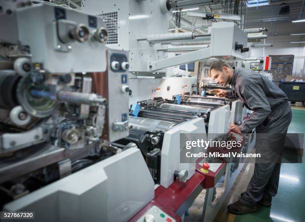 technician at work in label printing company - industrial machinery stock-fotos und bilder