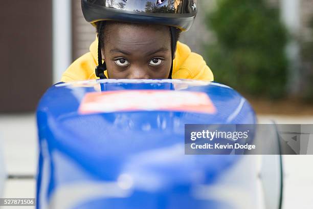 boy sitting in soapbox car - seifenkiste stock-fotos und bilder