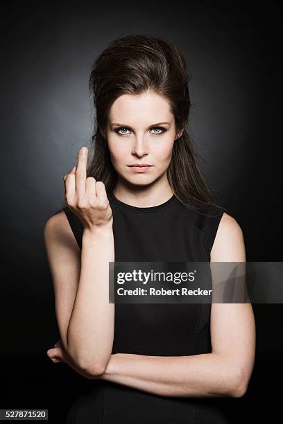 young woman showing middle finger - ののしりのジェスチャー ストックフォトと画像