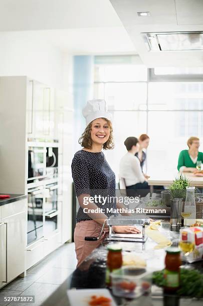 young woman cooking in modern kitchen - cooking class stockfoto's en -beelden