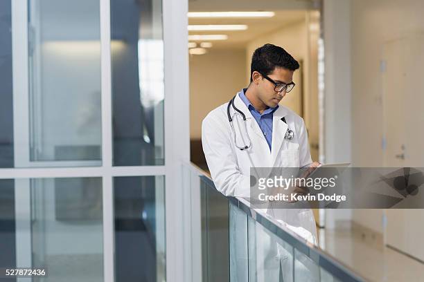 doctor using tablet pc in hospital - doctor reading stock pictures, royalty-free photos & images