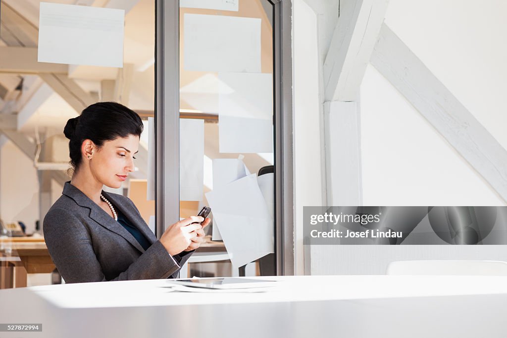 Texting Office Businesswoman Texting On Cell Phone In Office High-Res Stock Photo ...
