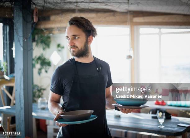 young bearded beach cafe owner - ober stockfoto's en -beelden