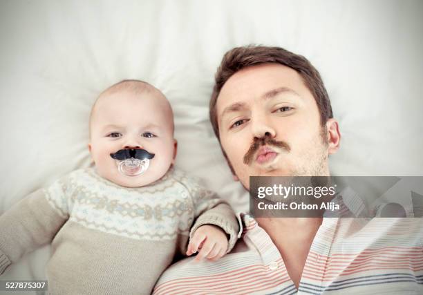 porträt von einem vater mit seinem sohn - moustaches stock-fotos und bilder