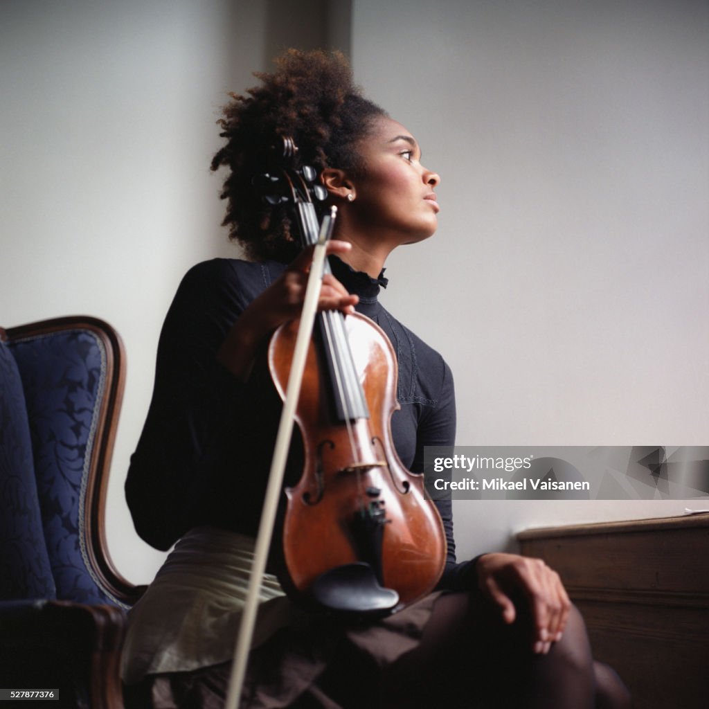 Young Woman Holding Violin