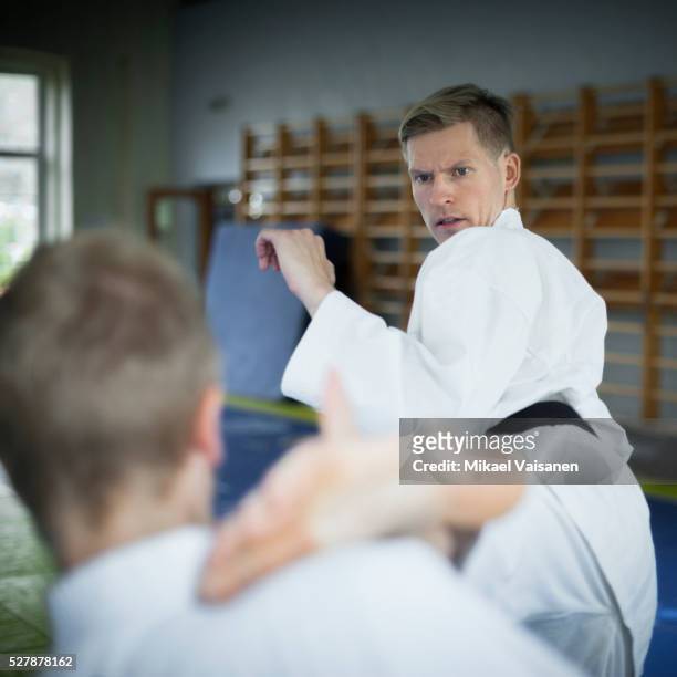 two karate practioners at training - teach to fight stock pictures, royalty-free photos & images