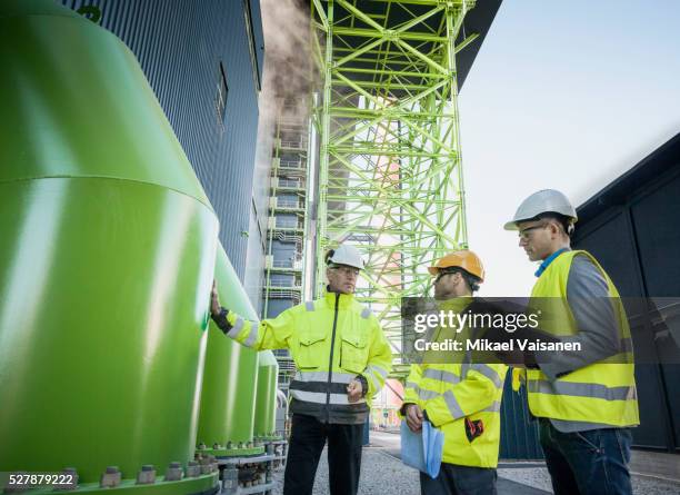 engineers on modern power station construction site - biomassa hernieuwbare energie stockfoto's en -beelden