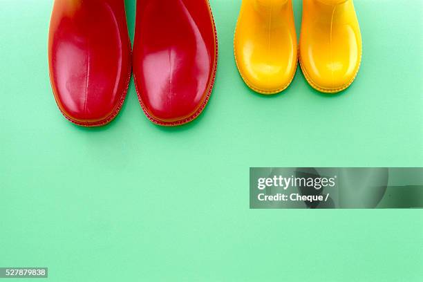 red and yellow galoshes - rain boots stock pictures, royalty-free photos & images