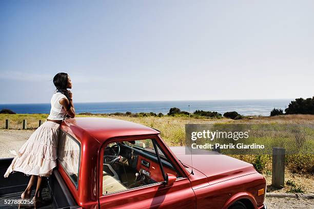 young woman in the back of a pickup - pick up truck back stock-fotos und bilder