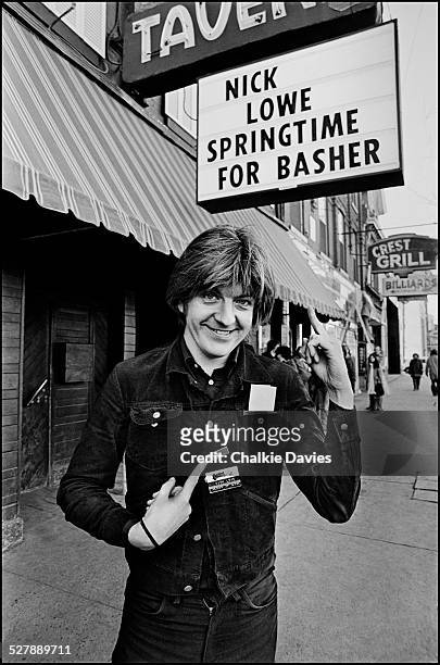 English singer-songwriter Nick Lowe outside the El Mocambo Nightclub in Toronto in March 1978. The sign reading 'Springtime for Basher' references...