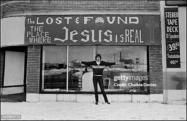 English singer-songwriter Nick Lowe in front of a thrift shop in Buffalo, New York, March 1978.
