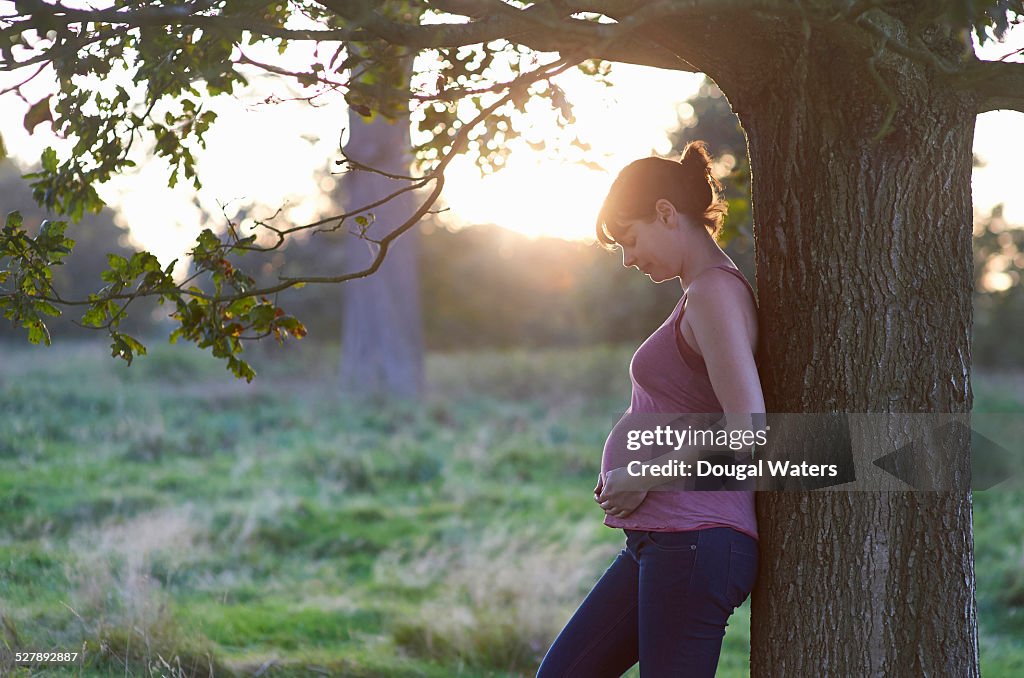 Pregnant woman in countryside.