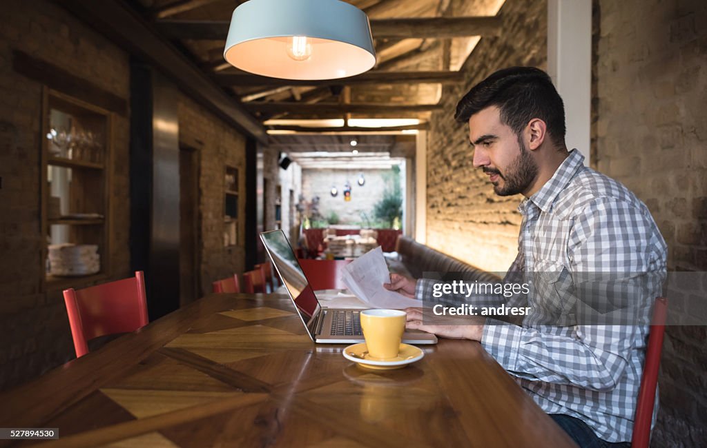 Business owner doing the books at a restaurant