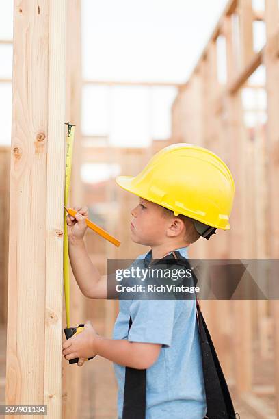 young boy dressed as carpenter with tape measure - utah house stock pictures, royalty-free photos & images