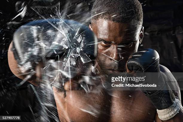 fighter punching close up glass shattering - mma fighter stock pictures, royalty-free photos & images