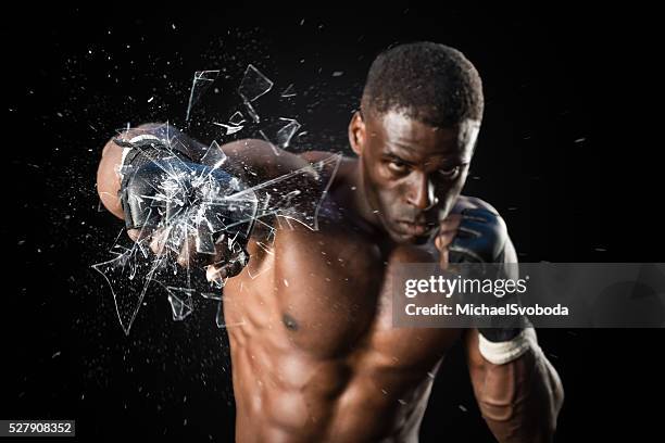 fighter punching close up glass shattering - punching glass stock pictures, royalty-free photos & images