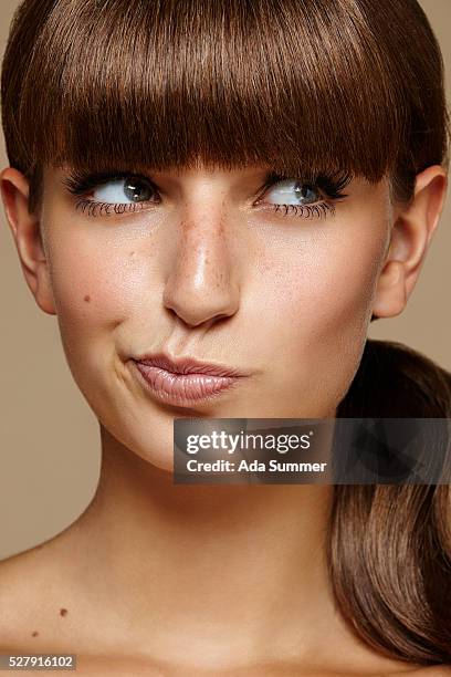 close up view of a young female adult making faces - eyelash extensions stock pictures, royalty-free photos & images