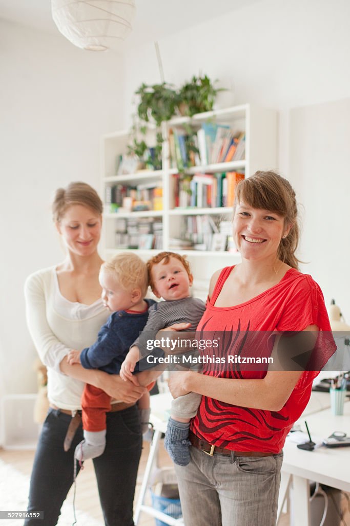 Two young mothers with baby children (6-12 months)