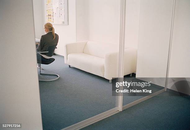 businesswoman at desk - glass door stock pictures, royalty-free photos & images
