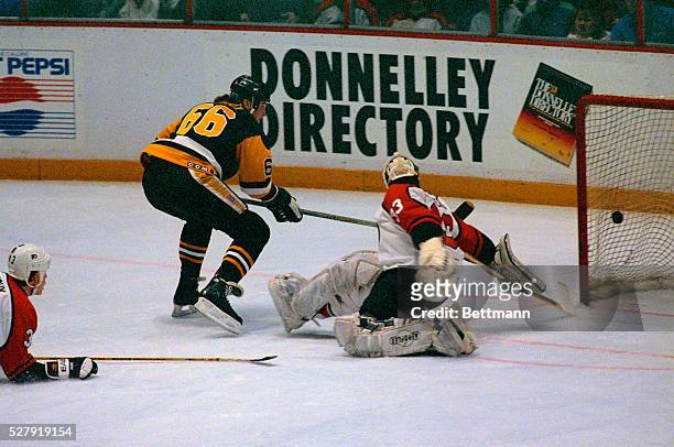 Pittsburgh's Mario Lemieux scores over the shoulder of Flyer's Pete Peters during 1st period Philadelphia Flyers-Pittsburgh Penguins NHL hockey...