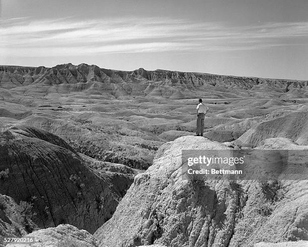 The Badlands, SD: Model Daniel Flesher stands on a hill overlooking the Badlands in South Dakota. Photo circa 1950.