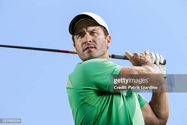 young man plying golf - golf shirt stock pictures, royalty-free photos & images