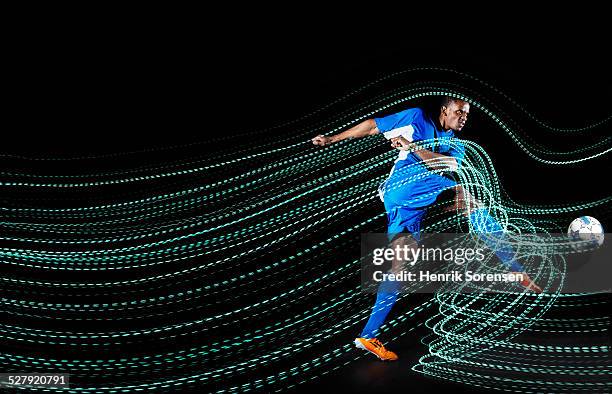 football/ soccerplayer with lighttrace - sports ball pattern stock pictures, royalty-free photos & images